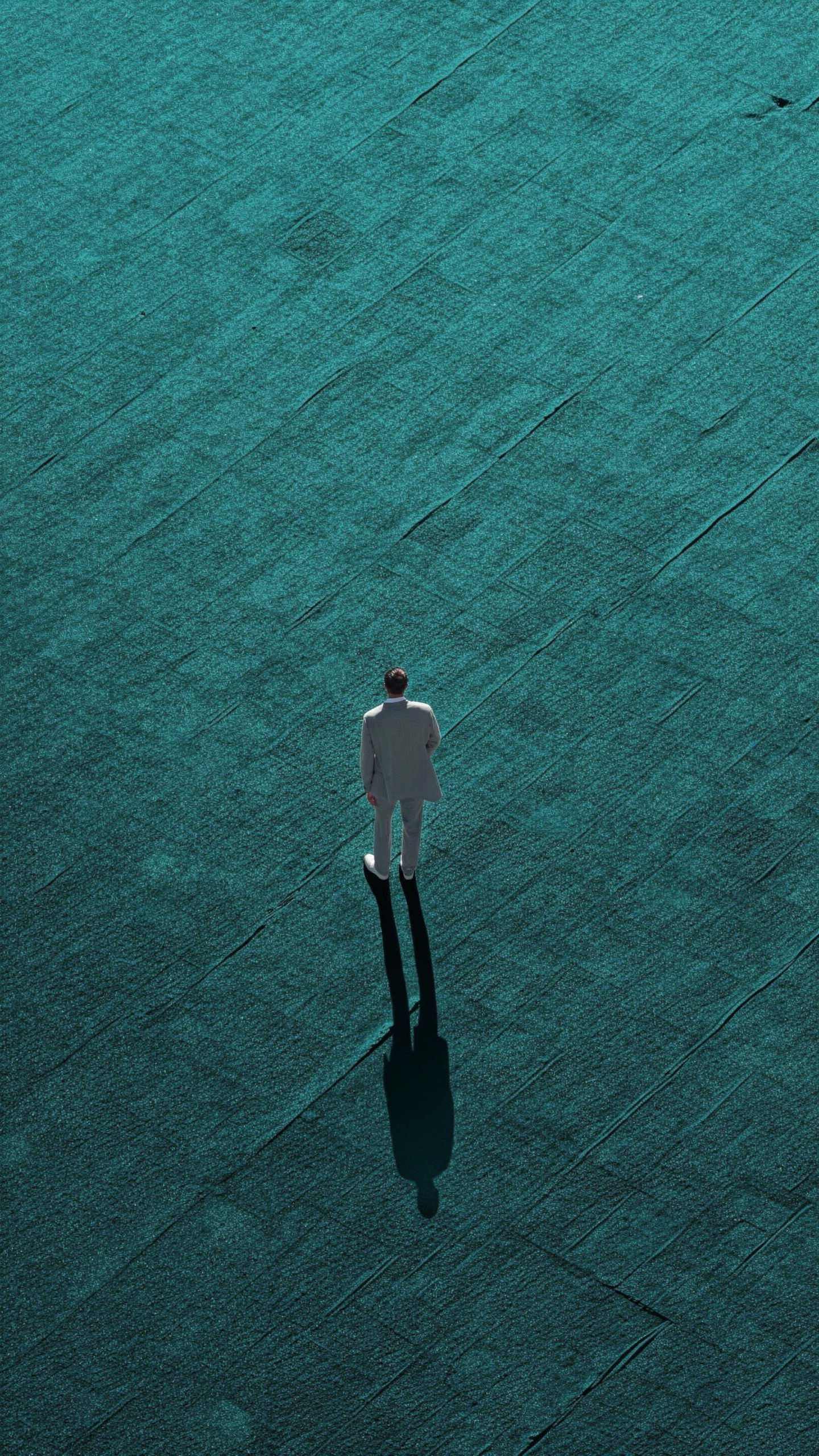 Charcoal-suited man on teal plane — flux-2-pro
