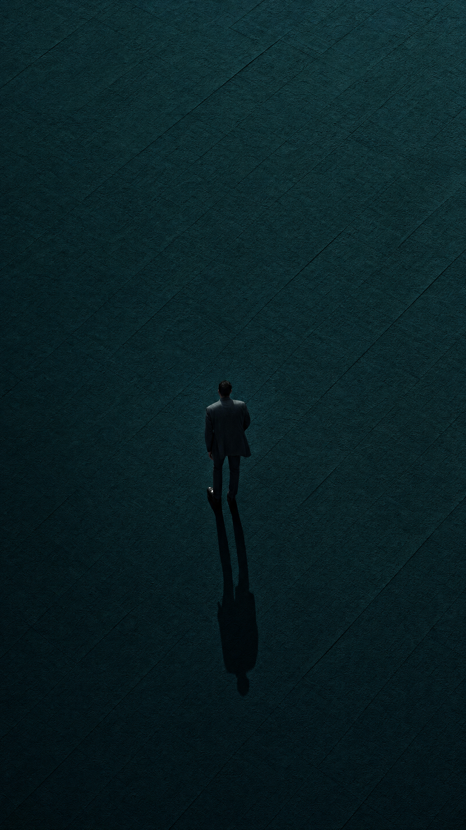 Charcoal-suited man on teal plane