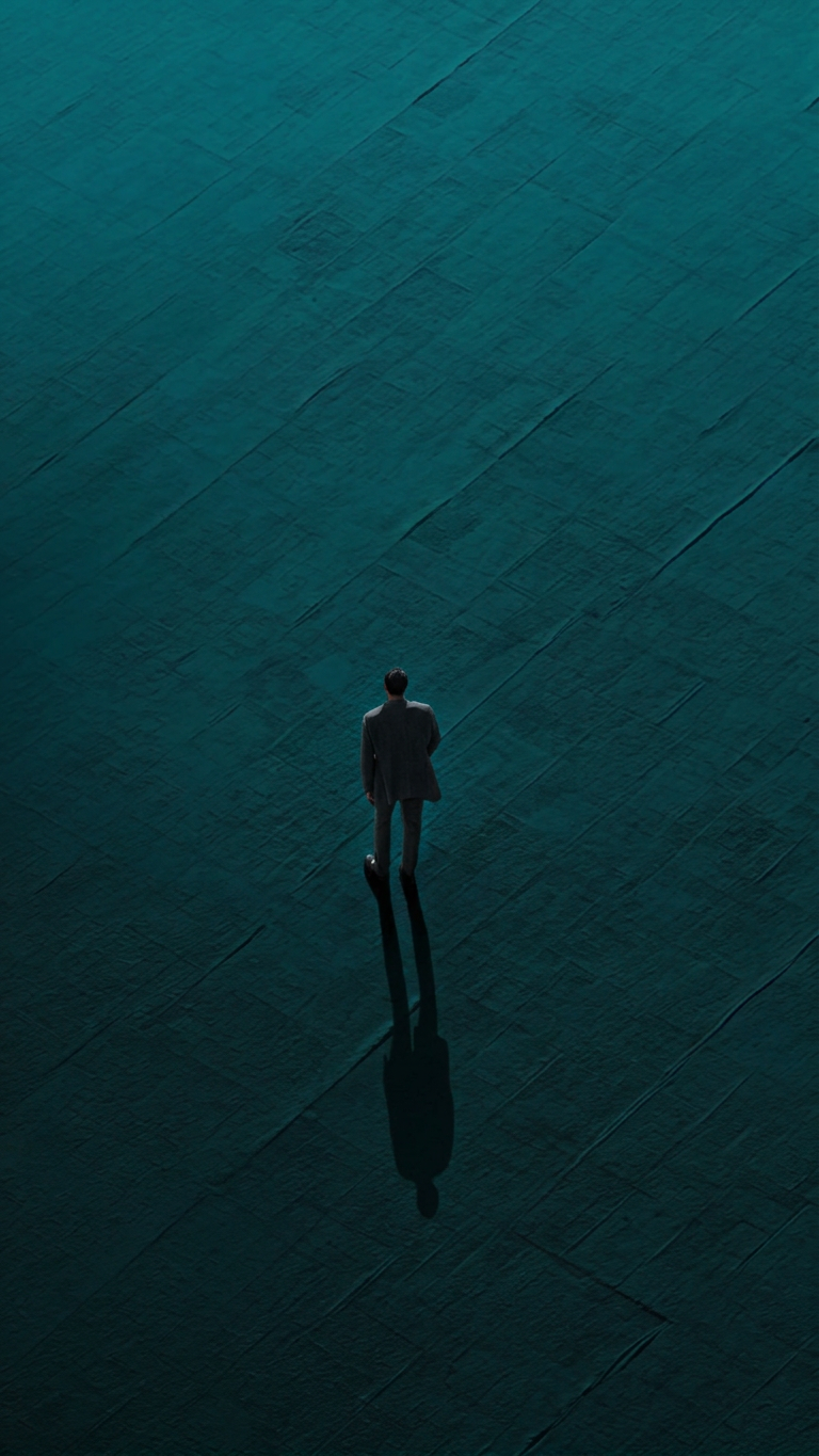 Charcoal-suited man on teal plane
