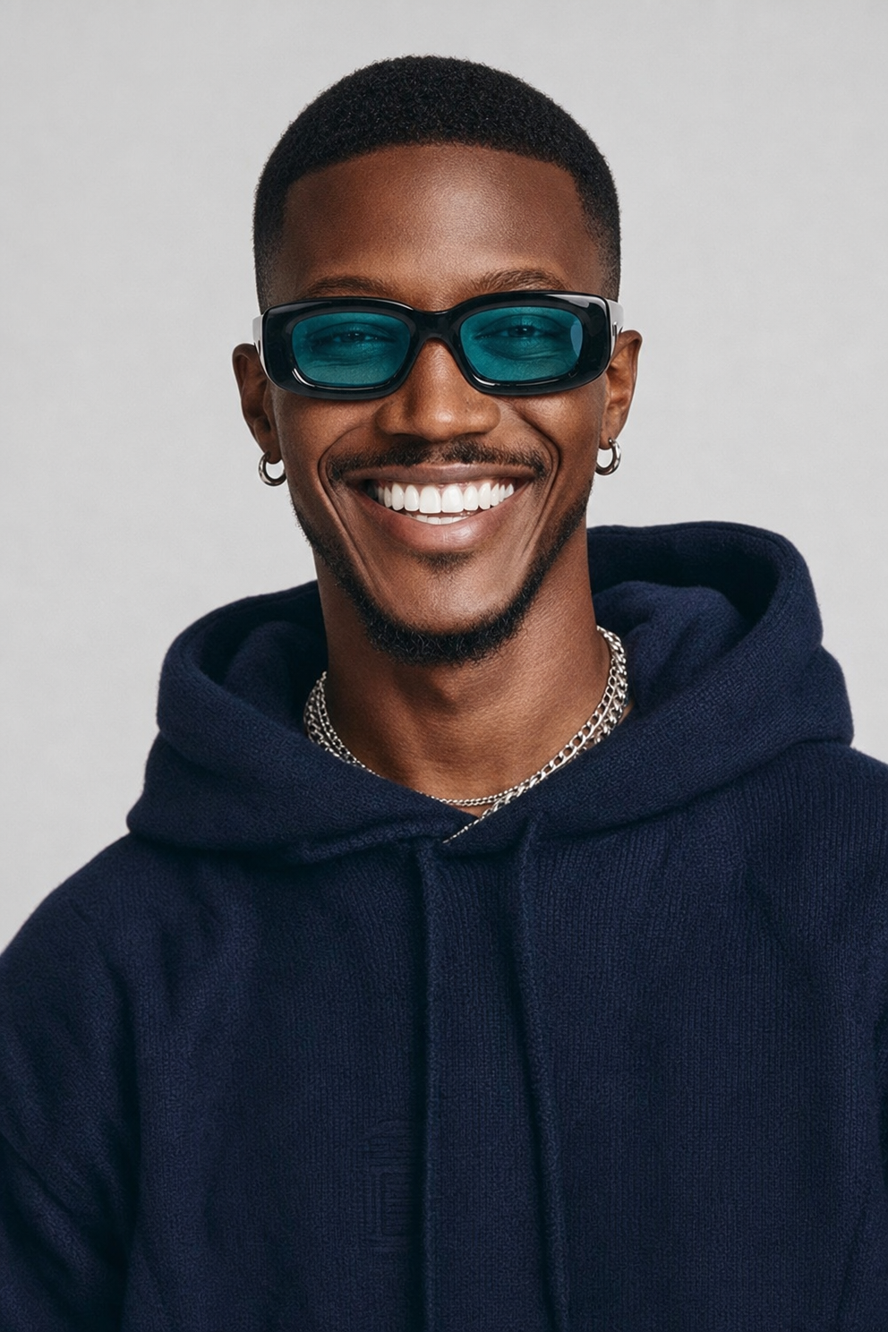 Confident studio portrait in teal tones