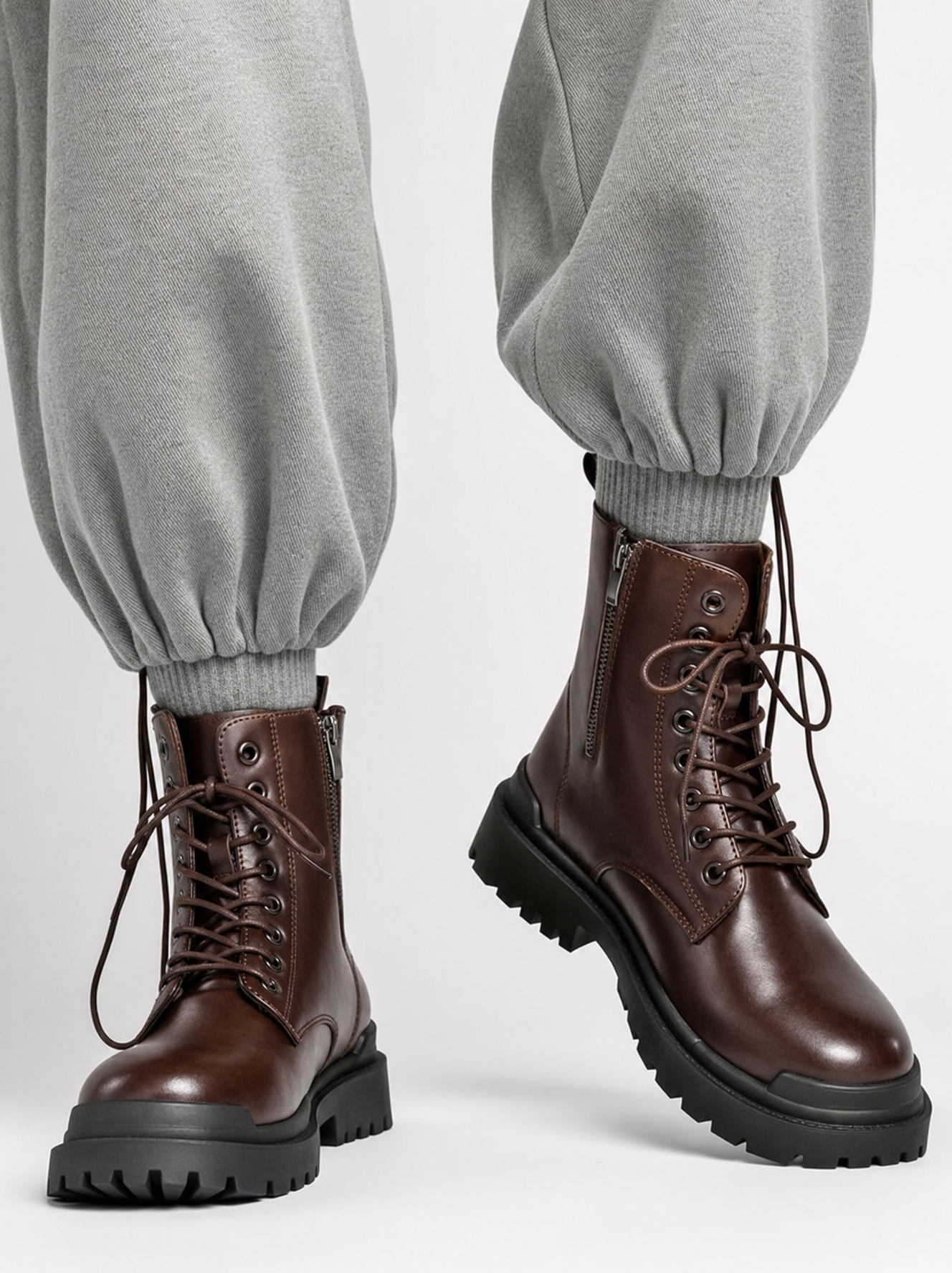 Dark brown leather combat boots with gray joggers