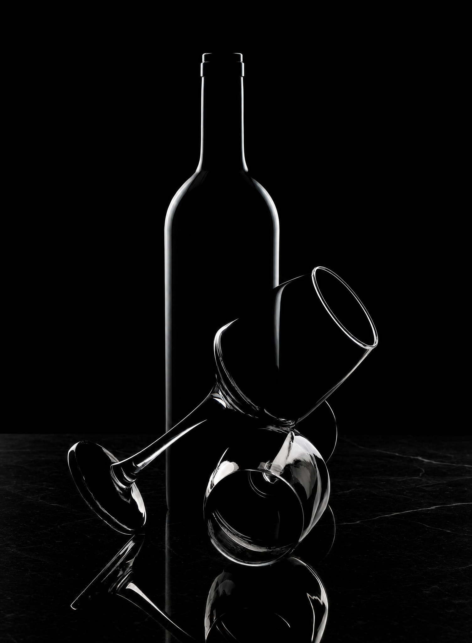 Dark Wine Bottle Behind Overturned Wine Glasses