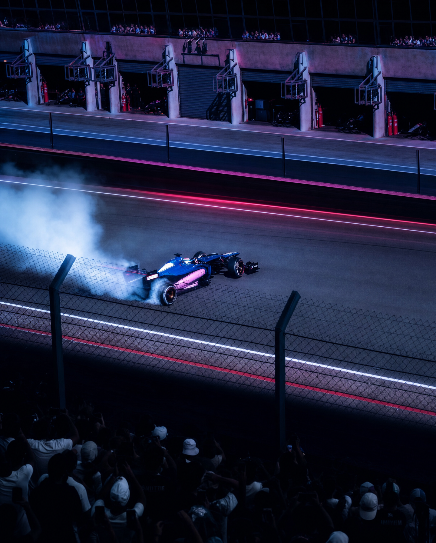 Formula car drift under blue floodlights