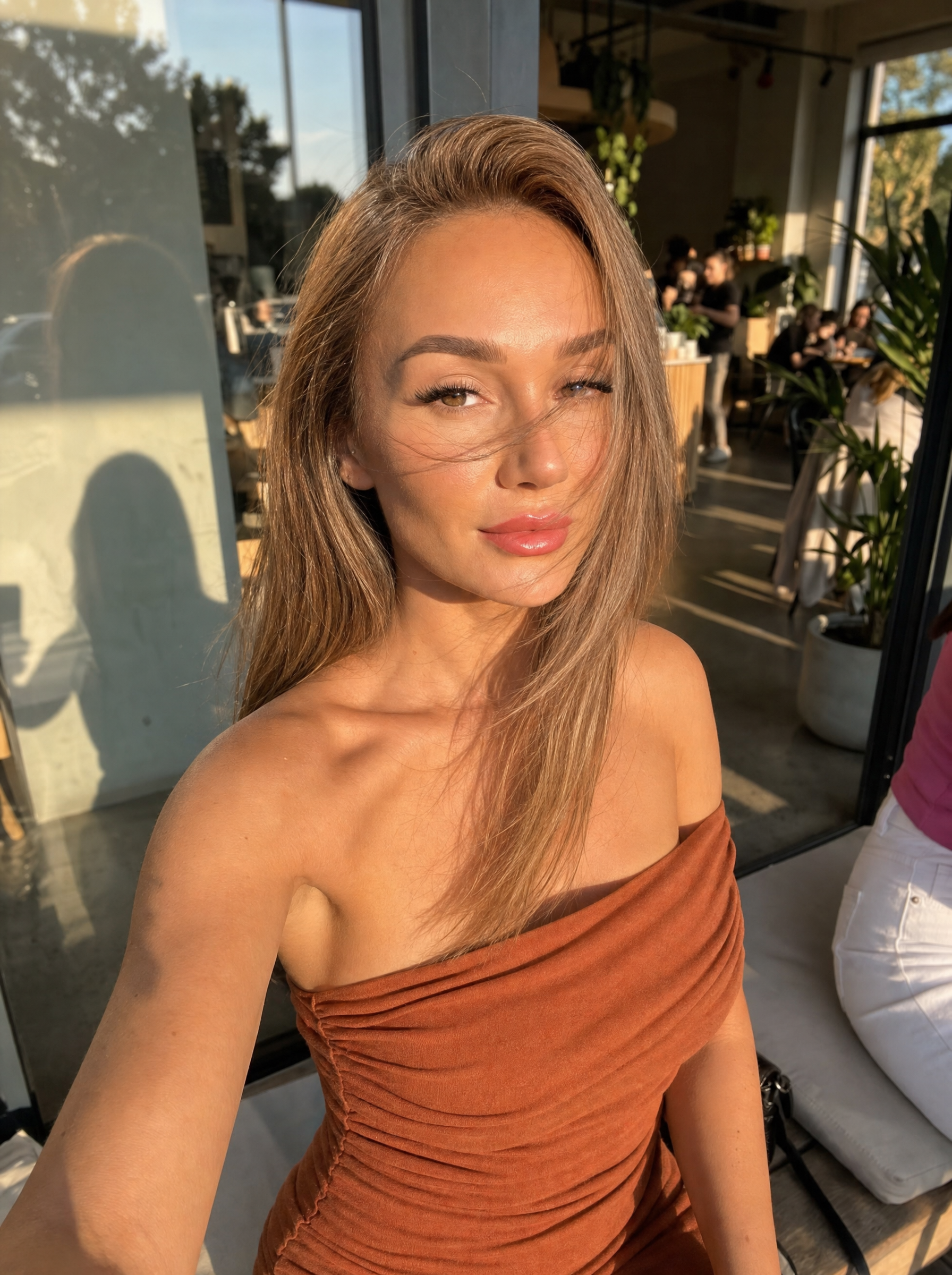 Golden-hour selfie at outdoor cafe