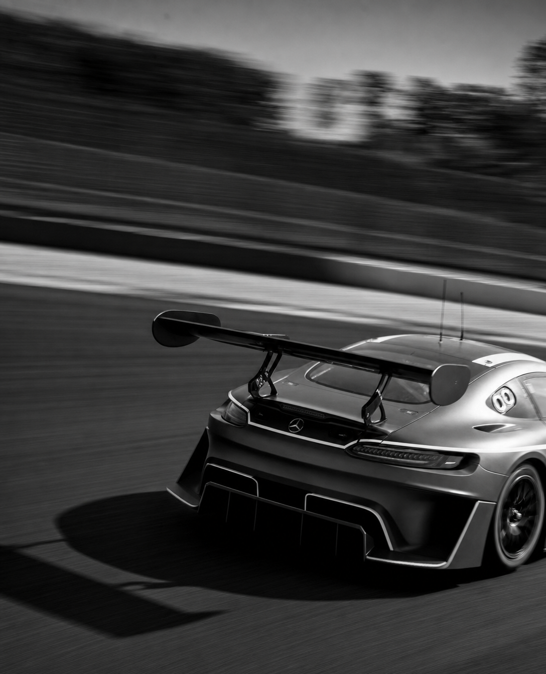 GT race car with wider splitter, black-and-white panning