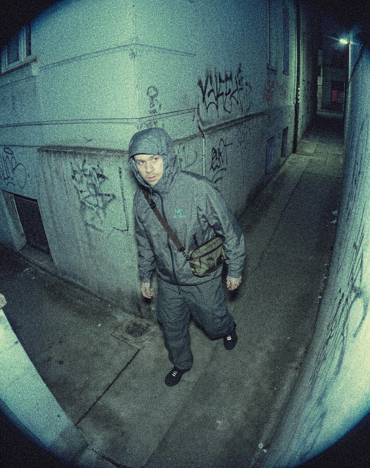 Hooded Figure Watches From Wet Alley