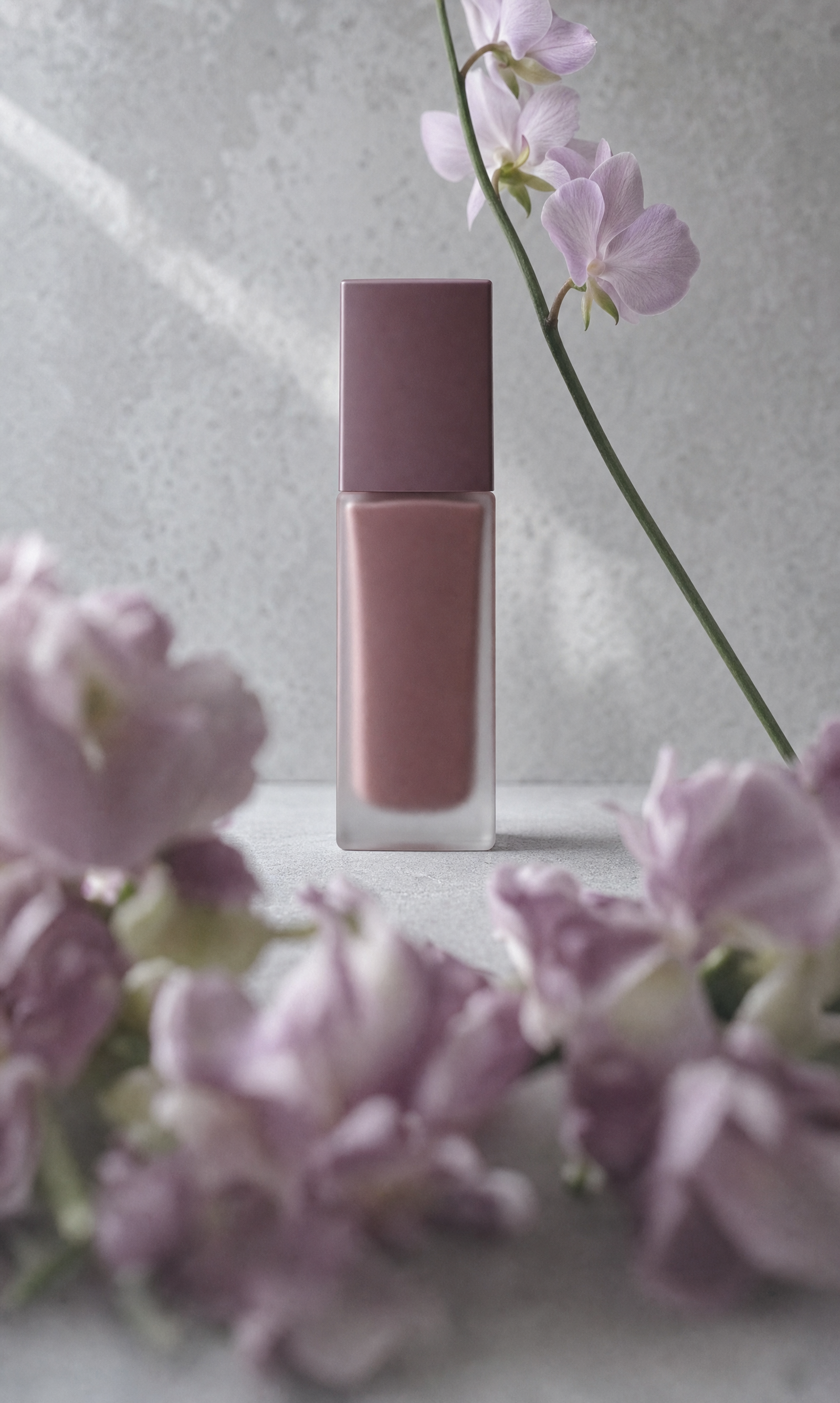 Matte deep-rose foundation bottle with lilac flowers