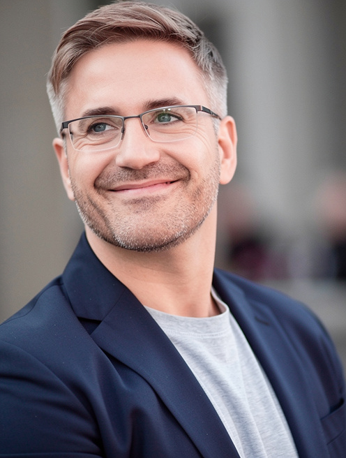 Middle-aged man with ash-brown hair and navy blazer