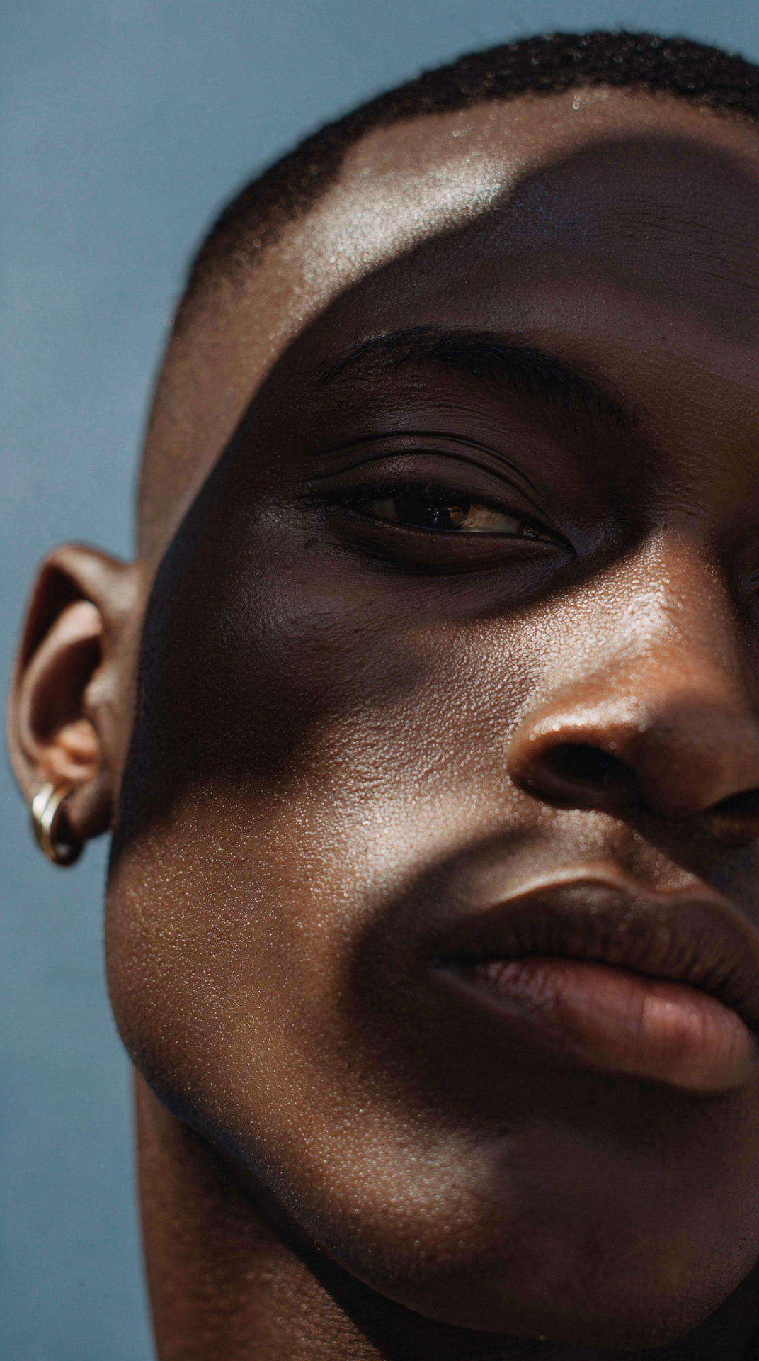 Moody side-lit editorial close-up portrait — flux-2-pro
