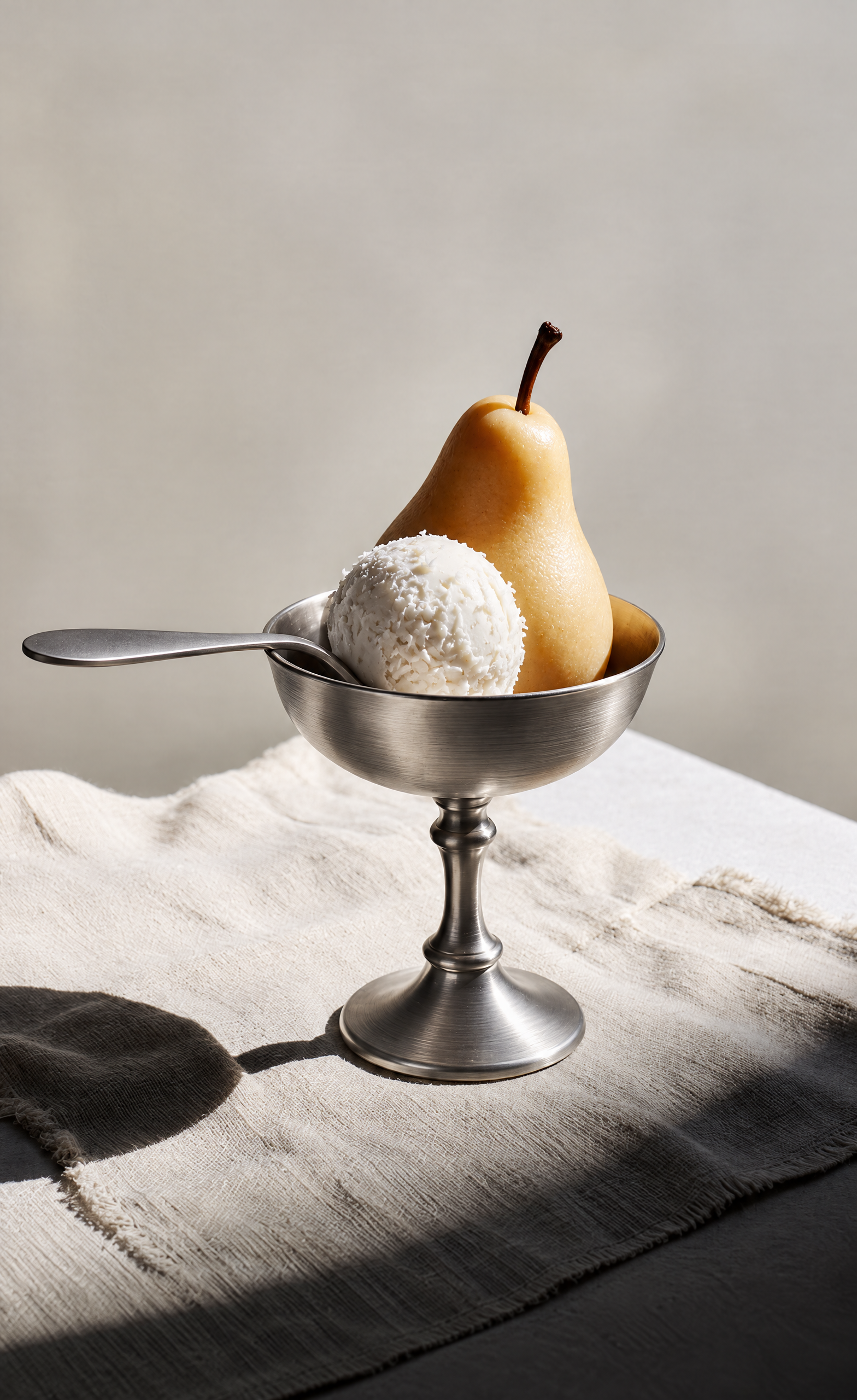 Poached golden pear with coconut ice cream spoon