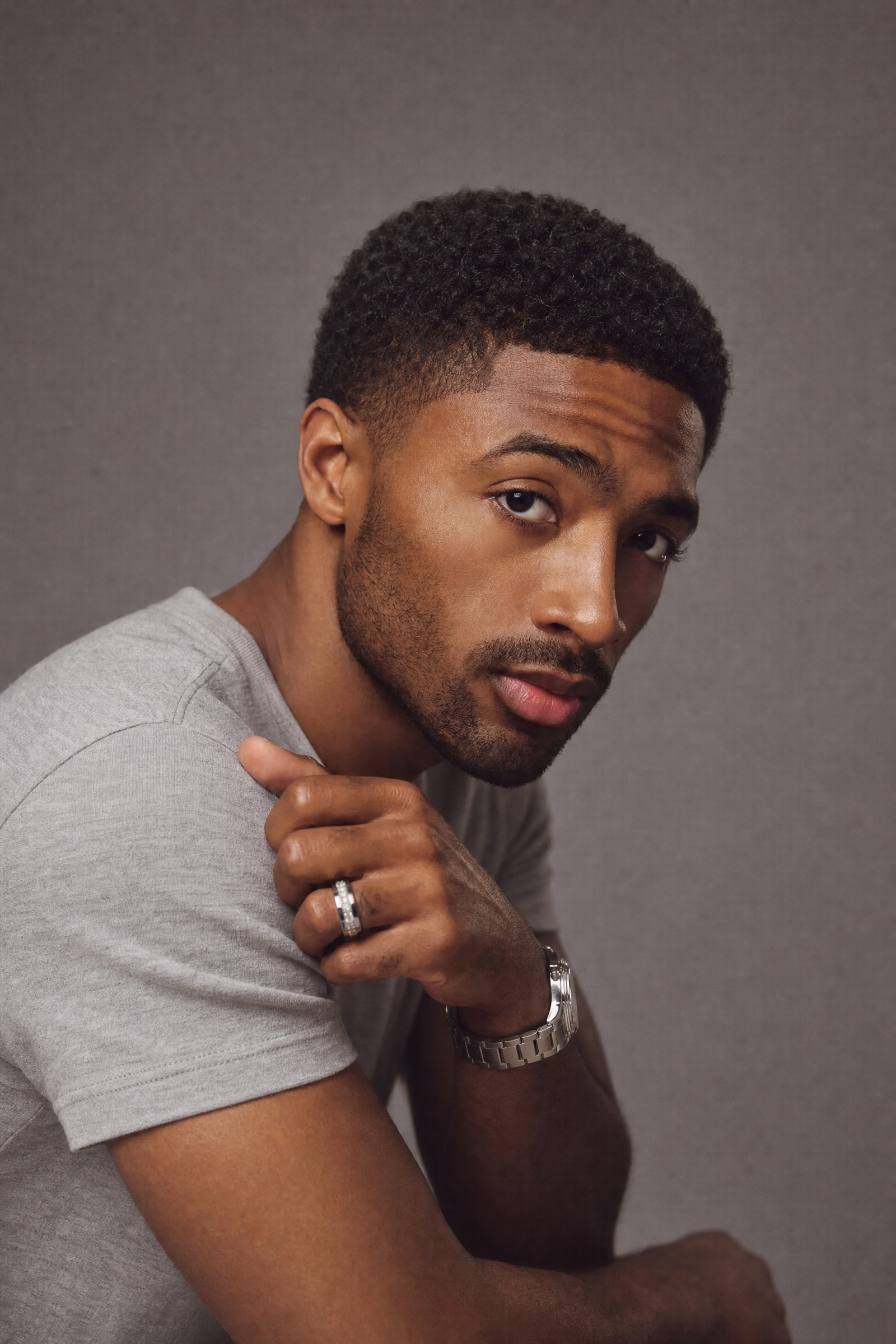 Young Black man with textured crop and light gray tee