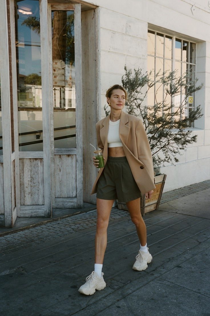 Young woman in cream top with tan blazer