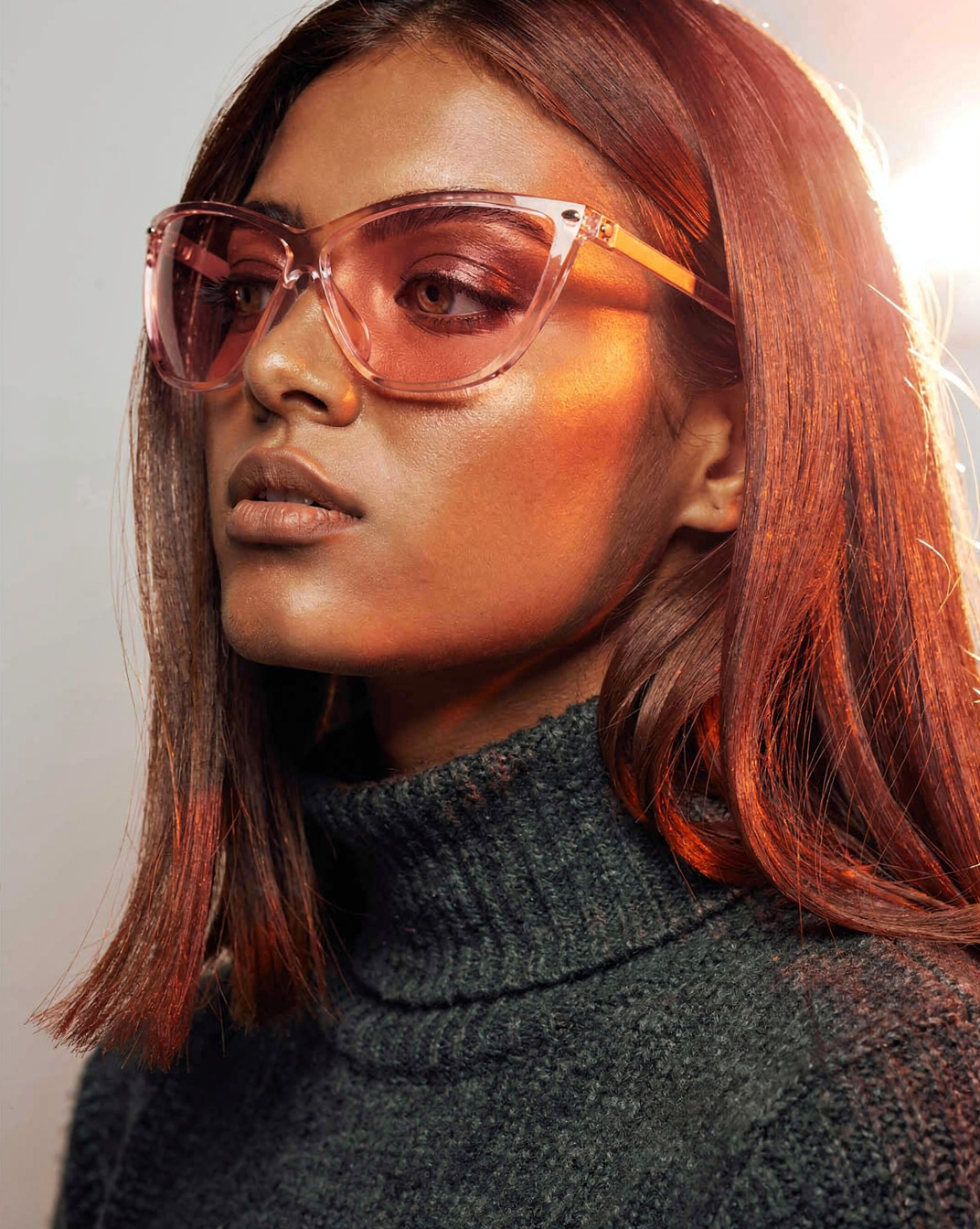 Young Woman in Rose-Tinted Glasses Profile